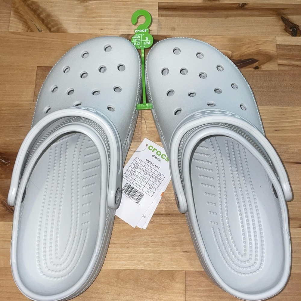 Brand new light blue/gray Crocs. Classic Clog. Men’s size 8, Women’s: size 10.